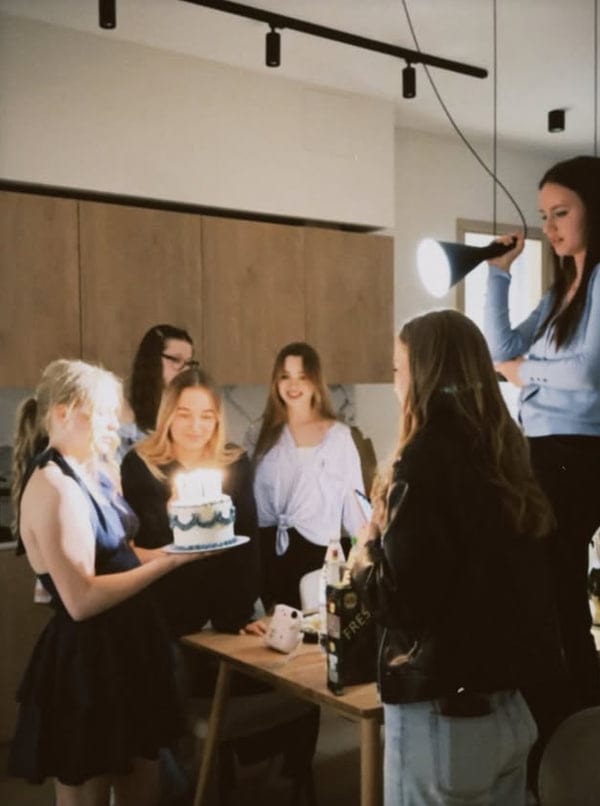 Candles on a cake, the room waiting to sing