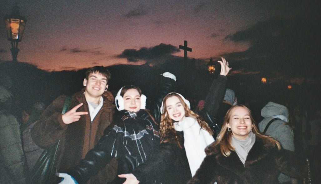 Everyone laughing at once, sunset behind