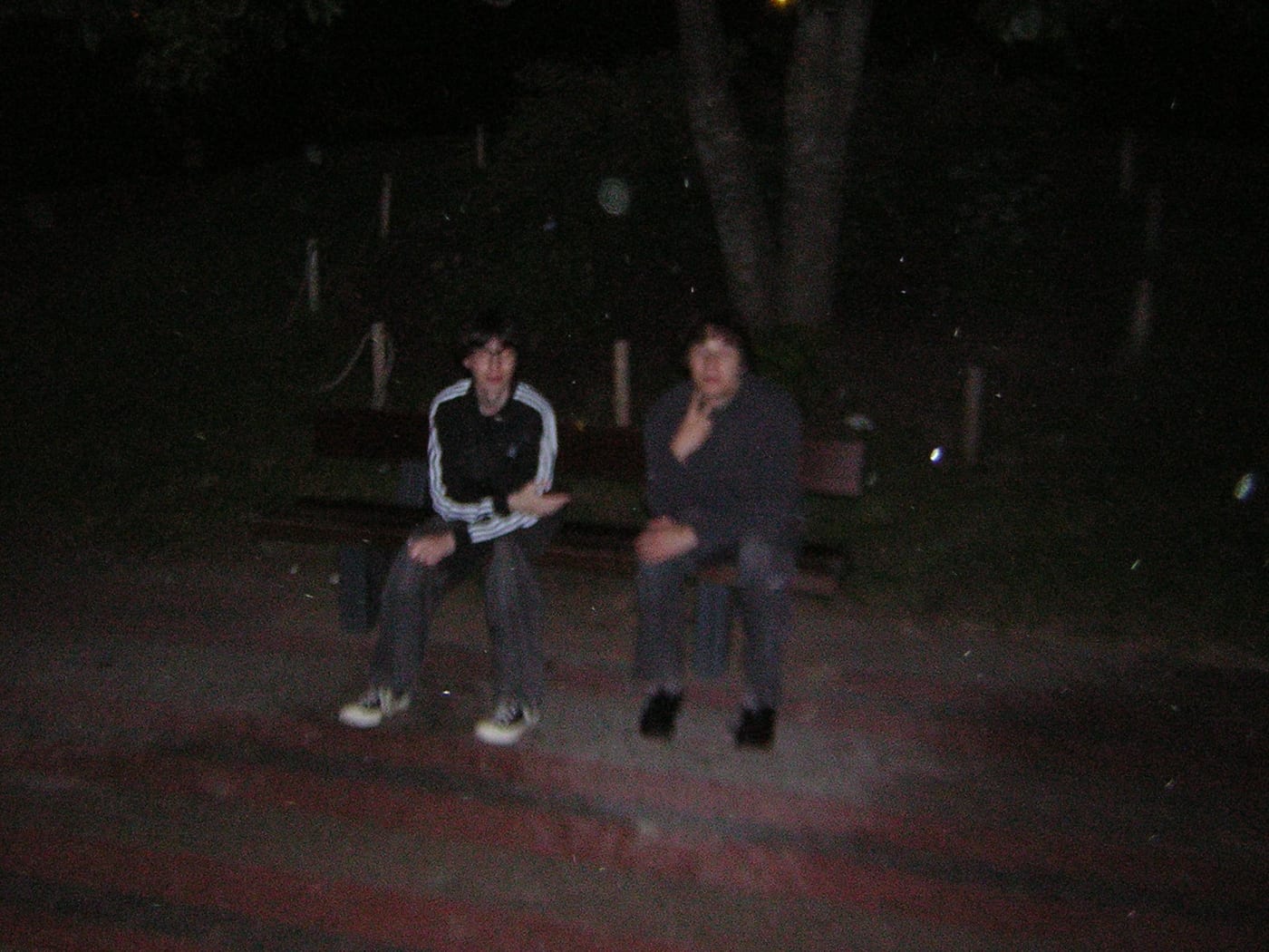 Two people on a bench, long after midnight
